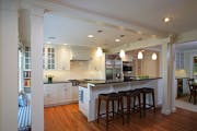 The kitchen was relocated from the middle to the front of the house to open up the floor plan and bring in more light.