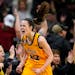Iowa guard Caitlin Clark, above celebrating after hitting a three-pointer against Michigan last February in Iowa City, leads a Final Four  contender.