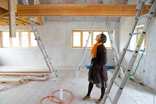 Katie Jones walked around her under-construction home on Thursday in Minneapolis. The house has straw insulation behind plaster to sequester carbon fr