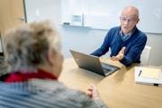 Bob Besinger meets with a client at the Trellis offices in Arden Hills, Minn., on Tuesday, Oct. 18, 2022. Every open enrollment season, Bob Besinger p