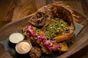 The Pescado Frito; fried red snapper, with coconut rice, pickled cabbage, grilled lime, patacones, and cotija, as prepared Wednesday, October 12, 2022