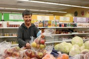 At the Interfaith Outreach Food Shelf in Plymouth, a volunteer restocked the fresh produce.