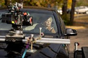 Marisa Coughlan in a scene that called for her to drive around Excelsior. The car was on a trailer for filming last week on the set of “Days When th