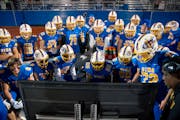 St. Michael-Albertville is one of a growing number of Minnesota high school football teams that use large TV monitors on the sideline.