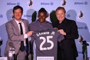 Amos Magee (shown at left next to former Loons player Darwin Quintero and coach Adrian Heath) is changing roles with the club. 