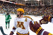 Gophers defenseman Jackson LaCombe, above celebrating a goal against North Dakota on Oct. 21, will play against No. 12 Notre Dame this weekend.