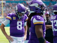 Minnesota Vikings quarterback Kirk Cousins (8) walks on the sideline in the first half of an NFL football game against the Miami Dolphins, Sunday, Oct