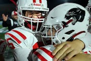 Lakeville North offensive lineman Cole Peterson, left, and defensive back Wyatt Brunello celebrate in the final moments of their game against Minneton