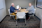 Bob Besinger meets with a client at the Trellis offices in Arden Hills, Minn., on Tuesday, Oct. 18, 2022.