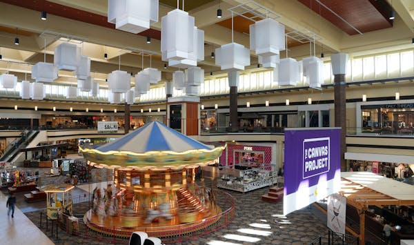 Children rode the carousel at Maplewood Mall, which will go up for sale in February.