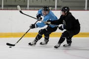 Whitecaps forward Stephanie Anderson (left) battled defender Sidney Morin during Tuesday’s practice at the Richfield Ice Arena.