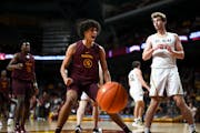 Minnesota Gophers forward Kadyn Betts (15) celebrates after dunking the ball against St. Olaf during the first half of an NCAA basketball game Wednesd