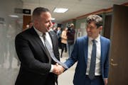 Brian O’Hara, left, walked with Mayor Jacob Frey after he was voted in as the new Minneapolis Police chief in the City Hall, Council chambers in Min