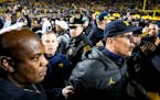Michigan State coach Mel Tucker, left, and Michigan coach Jim Harbaugh headed toward the tunnel at Michigan Stadium after the Wolverines’ 29-7 victo