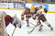 Gophers forward Abigail Boreen takes the puck to the net while being defended by Minnesota Duluth forward Clara Van Wieren in the second period Saturd
