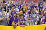 Vikings fans celebrate at FedEx Field after the team’s 20-17 victory over the Washington Commanders on Sunday. 