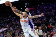 Devin Booker of the Suns battled the Sixers’ P.J. Tucker for a rebound Monday night in Philadelphia. Phoenix plays the Timberwolves on Wednesday at 