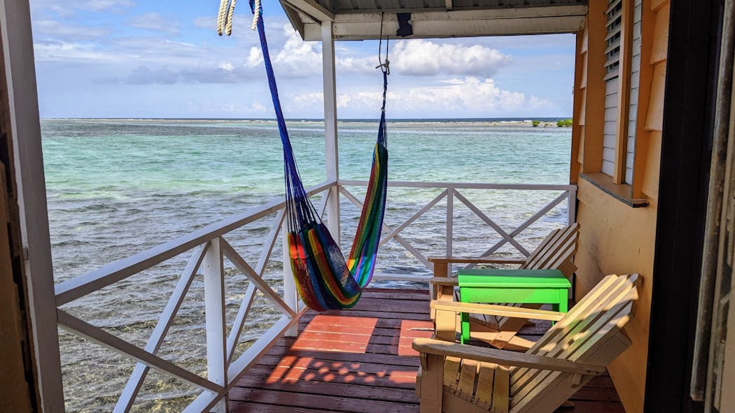The patio of an over-water cabana at Tobacco Caye Paradise offers an private view of the Caribbean.