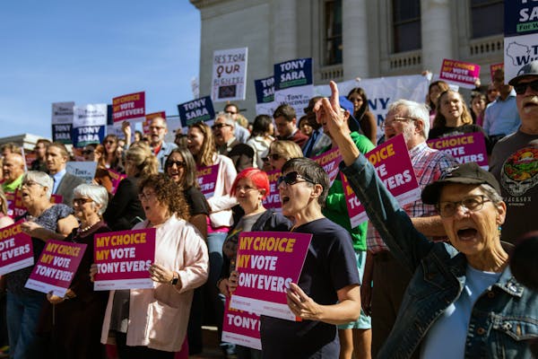 Abortion rights activists cheered Wisconsin Gov. Tony Evers during a re-election campaign rally outside the state Capitol in Madison, on Oct. 4, 2022.
