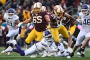 Gophers running back Mohamed Ibrahim (24) broke a tackle by Northwestern Wildcats defensive back A.J. Hampton Jr. (11) during the first half Saturday.
