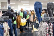 File photo shows workers stocking the women’s clothing section of Nordstrom Rack at the IDS Center in downtown Minneapolis just before it opened in 