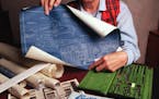 Loraine Plasman in 1995, at her home in Bloomington with some of the blueprints and drafting tools that she used as a Curtis-Wright “cadette” at t