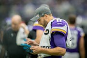 Quarterback Kirk Cousins, shown with a sideline tablet in 2019, is an avid watcher of film.