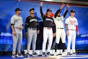 From left, Twins players Luis Arraez, Jorge Polanco, Joe Ryan, Byron Buxton and Jose Miranda pose for a photo in their new uniforms  at the Mall of Am