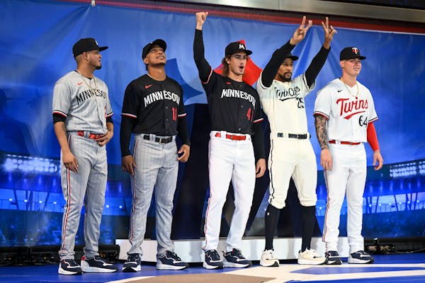 From left, Twins players Luis Arraez, Jorge Polanco, Joe Ryan, Byron Buxton and Jose Miranda pose for a photo in their new uniforms  at the Mall of Am