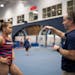 Suni Lee listened to instructions from coach Jeff Graba last December at Auburn.