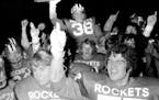 Start of a trend: Rochester John Marshall linebacker Jack Draws, surrounded by teammates, hoisted the 1973 Class AA championship trophy after the Roc