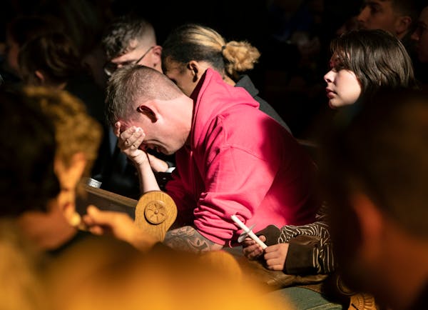 R.J. Lewis sobs in the pews of All Souls Unitarian Church at the start of a service held for people to mourn following a fatal shooting at Club Q in C