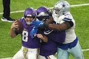 Vikings coach Kevin O’Connell said left tackle Christian Darrisaw, center, sustained a concussion on this play in the second quarter. 