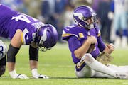 Vikings quarterback Kirk Cousins had to pick himself up after being sacked by DeMarcus Lawrence of the Cowboys in the third quarter.