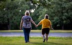 Jody Brennan and her daughter Maddie, who has Down syndrome and lives at a Bridges MN group home, on a walk at Memorial Park in Shakopee, Minn.