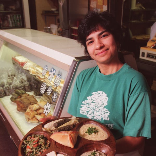 Amy Awaijane, part-owner of Emily’s Lebanese Delicatessen in Minneapolis, displays a few of the shops specialties including tabouleh, hummus, baba g