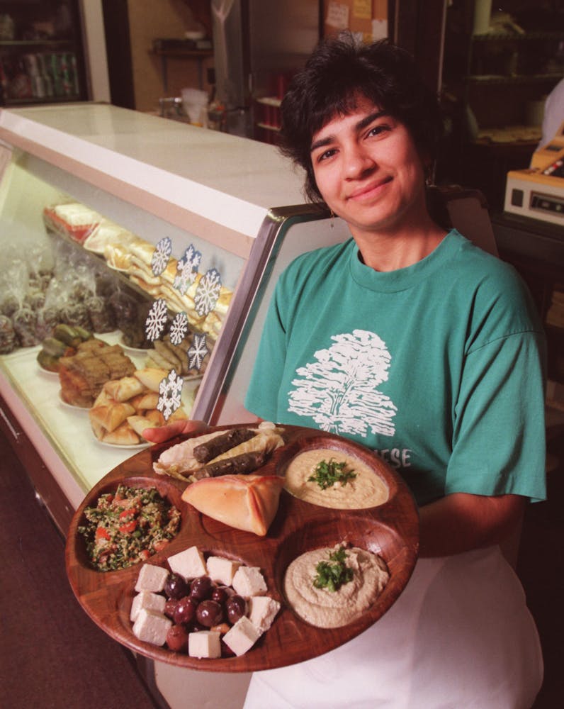 Amy Awaijane, part-owner of Emily’s Lebanese Delicatessen in Minneapolis, displays a few of the shops specialties including tabouleh, hummus, baba g