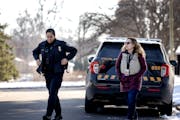 Ramsey County social worker Amy Kuusisto-Lathrop and Maplewood police officer Emily Burt-McGregor walked from a squad car on Nov. 21.