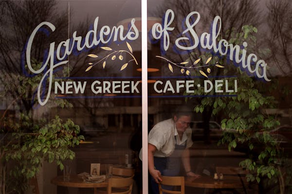 Taste East Hennepin Neighborhood story on the eating establishments. — Anna Christoforides cleans up the tables in the window at The Garden Of Salon
