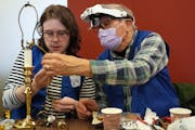 Caleb Ihla got help from his grandfather Rod Basham as he fixed a lamp during a Ramsey County fix-it clinic Saturday, Nov. 19, at the Ramsey County Li
