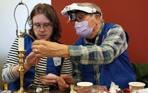 Caleb Ihla got help from his grandfather Rod Basham as he fixed a lamp during a Ramsey County fix-it clinic Saturday, Nov. 19, at the Ramsey County Li