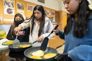 Marlene Gil Ortiz, Jolet Juarez Parra and Judith Cortes Rosas, left to right, cook pupusas during a culinary arts class at Roosevelt High School in Mi