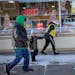 A family makes their way on a sidewalk in the downtown area in Worthington, Minn., earlier this month.