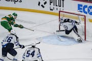 Marcus Foligno of the Wild scored against Jets goalie Connor Hellebuyck on Nov. 23 at Xcel Energy Center.