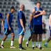 England’s Harry Kane, middle, stands on the field during England’s official training before its World Cup match against the United States.