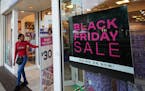 Shoppers exit a Claire’s accessories store advertising sales ahead of Black Friday and the Thanksgiving holiday, Monday, Nov. 21, 2022, in Miami. Re