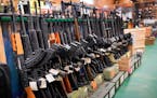 Semi-automatic rifles are seen at Coastal Trading and Pawn, in July in Auburn, Maine.