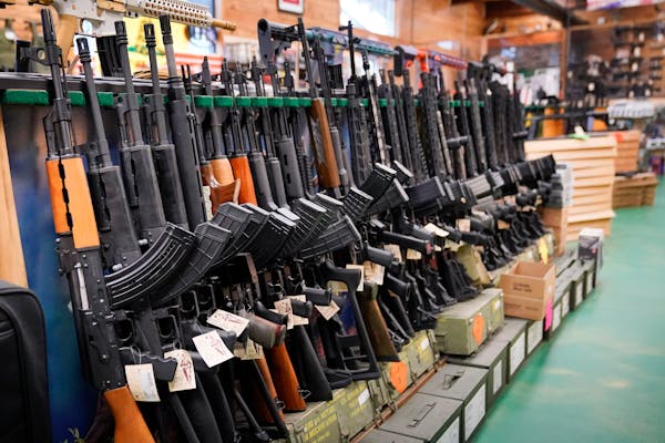 Semi-automatic rifles are seen at Coastal Trading and Pawn, in July in Auburn, Maine.