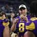 Minnesota Vikings quarterback Kirk Cousins holds a piece of turkey during a post game celebration following a 33-26 win against the New England Patrio