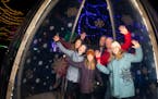 Monica Guggenberger, left, posed in the Hollidazzle Snowglobe with her two dads Paul Reichert and Curt Rock and her three girls Navaya, 11, Nora, 8, a
